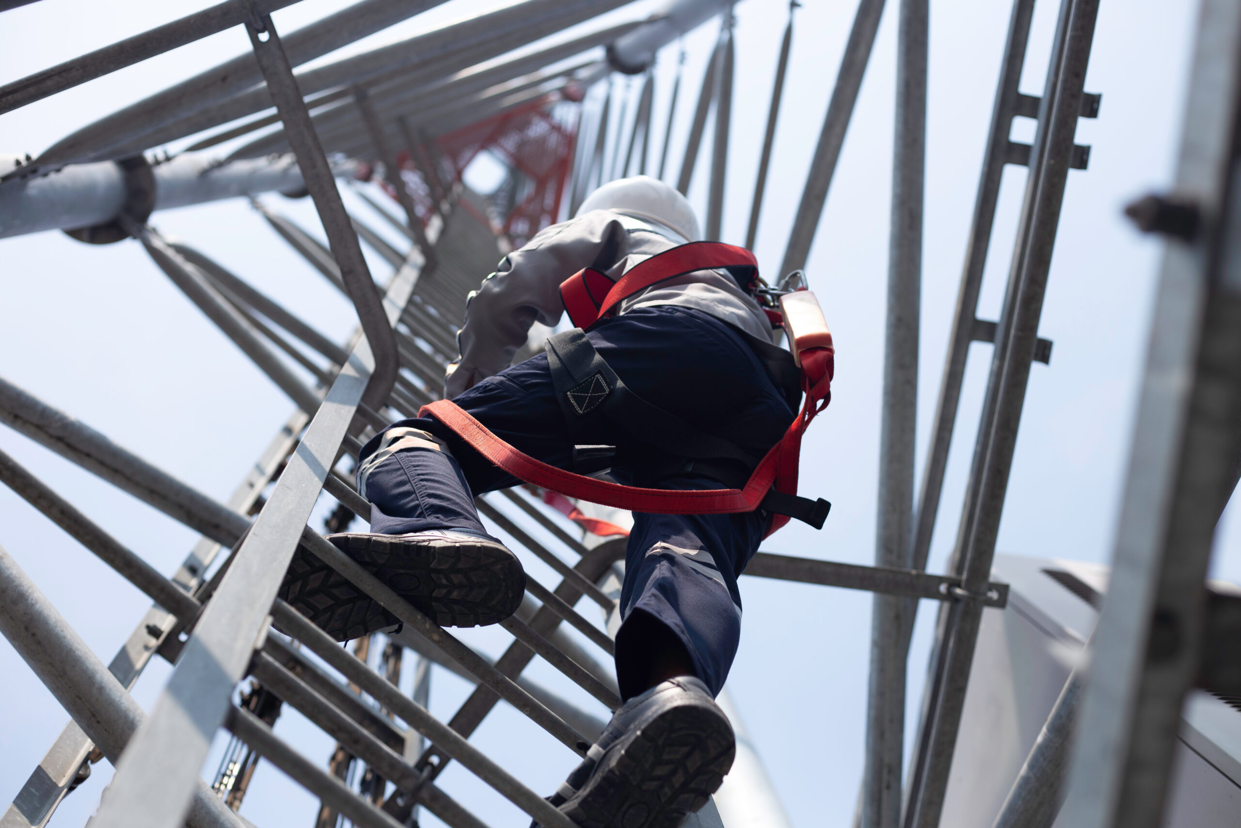 Engineer wear safety equipment climb high telecom tower for main